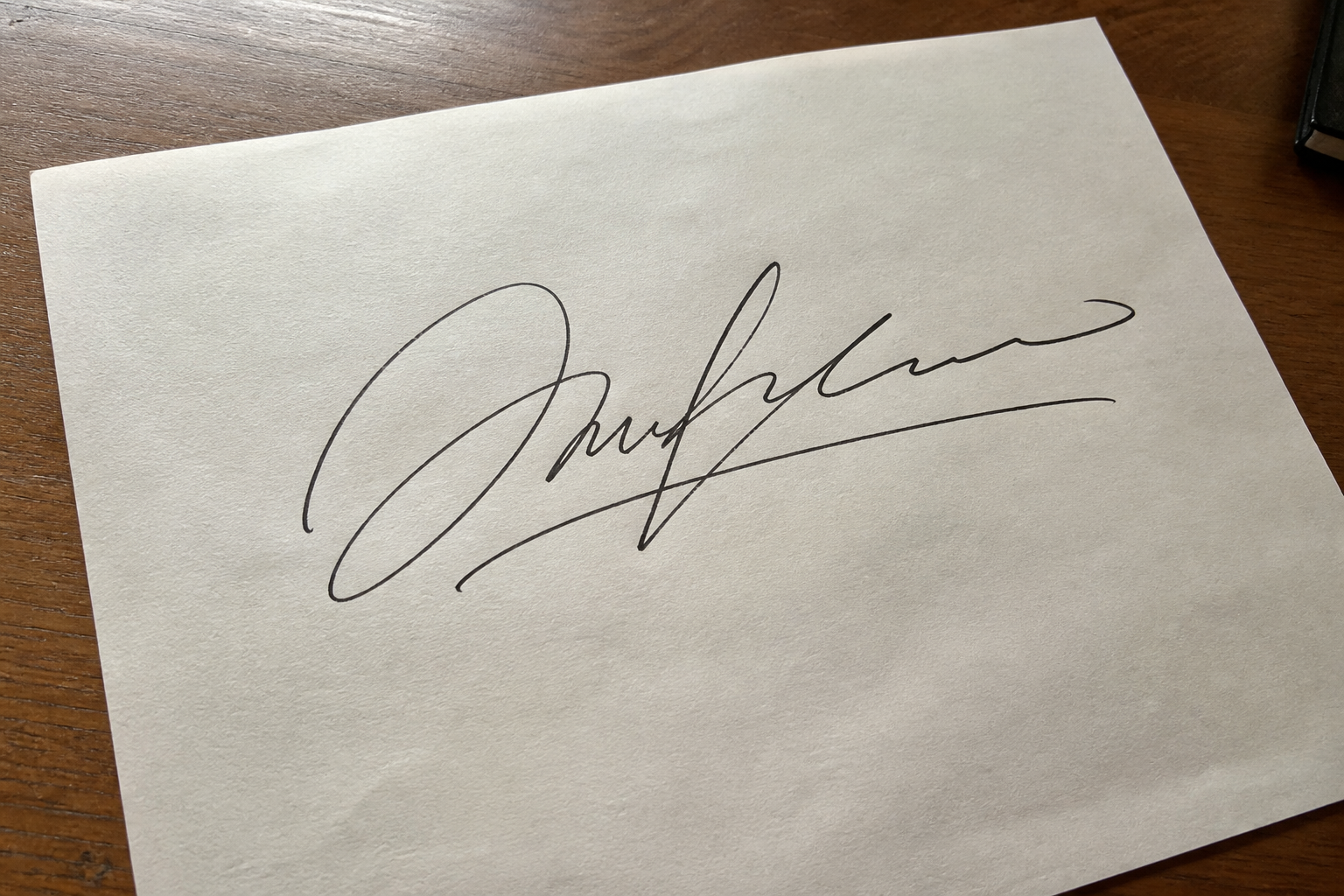 Handwritten signature on white paper before background removal