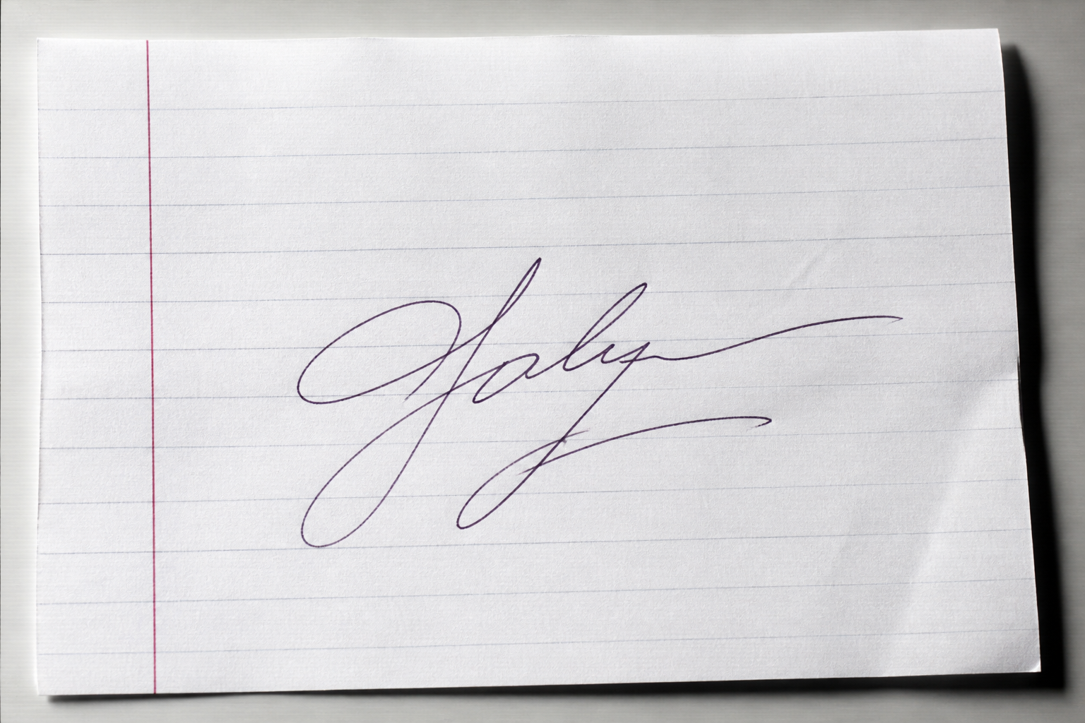 Scanned handwritten signature with ruled paper, red margin, and paper texture before background removal